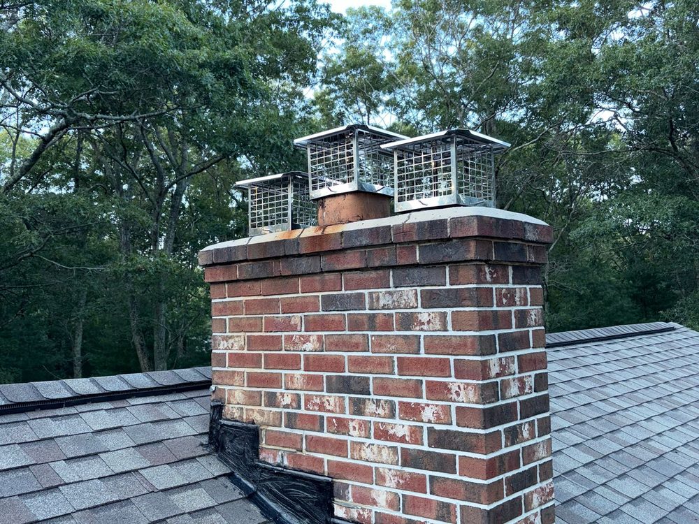 The same chimney after work, with new
               caps fitted and flashing sealed