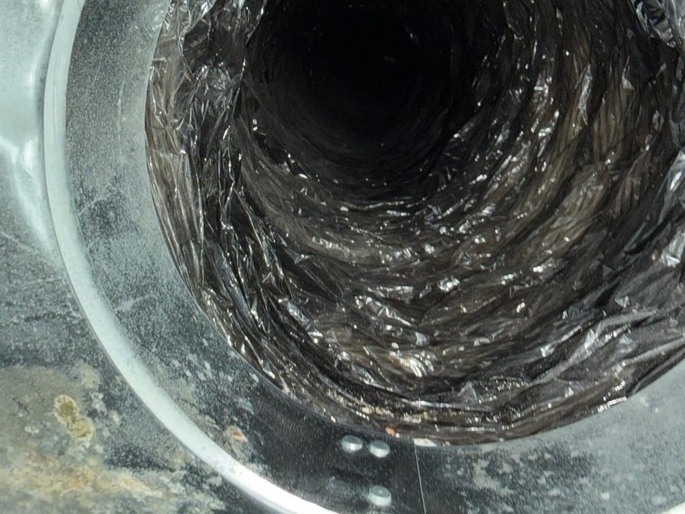 Inside a flexible air duct, coated in dust
               before cleaning